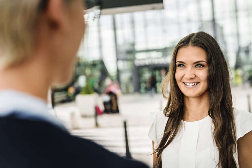 A sales and marketing professional interacting with a person face-to-face
