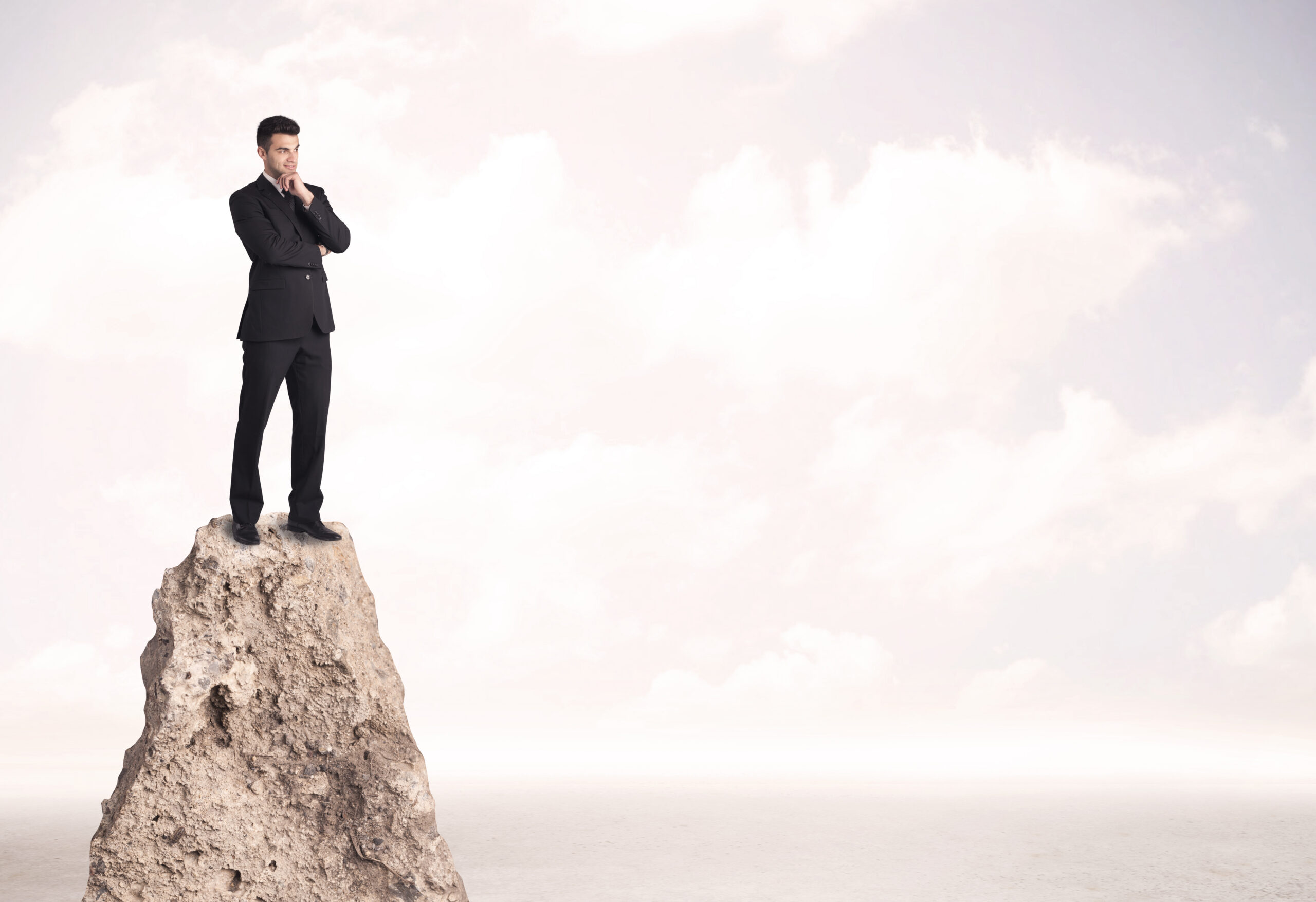 A professional with a sales mindset while standing on a cliff