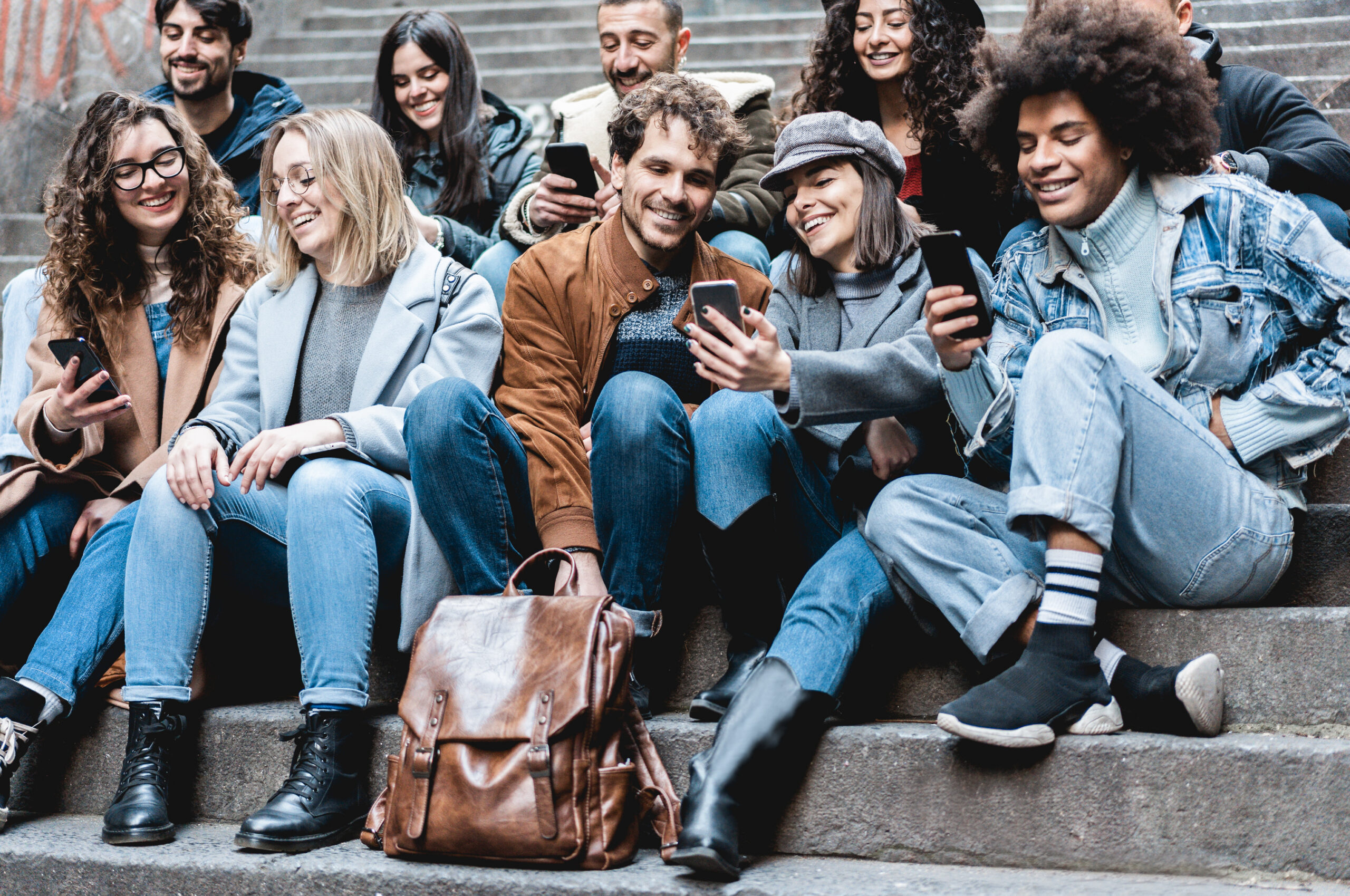 A group of Gen Z marketing professionals on their phones